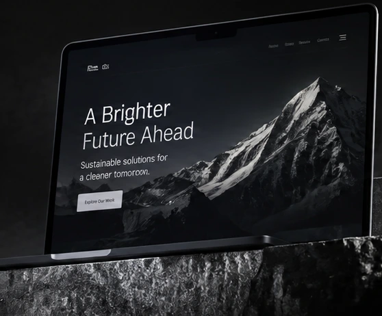 Website concept displayed on a black laptop and sculptural stone plinth